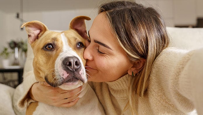 A woman hugging her dog A woman hugging her dog
